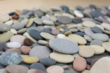 Different colored pebbles or beach stones on a beach.の写真素材