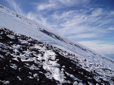 Type of the mountain ice-covered declivity on background skyの写真素材