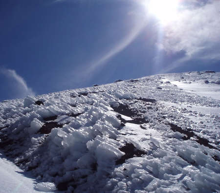 Type of the mountain ice-covered declivity on background skyの写真素材