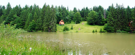 panaramic landscape lake with lodge ashore.の写真素材