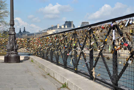 many castles on the railing of the bridge in Parisの写真素材