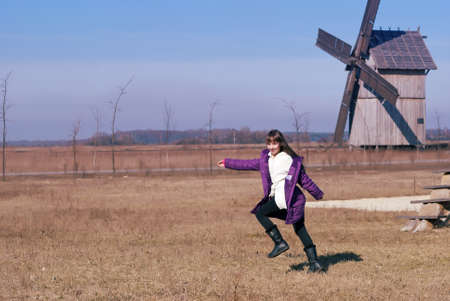 Teen girl runs across the field in the countrysideの写真素材