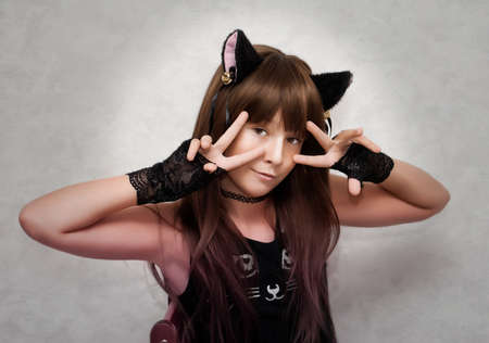 Portrait of cute teen girl disguised as a kitten.の写真素材