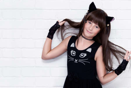 Portrait of cute teen girl disguised as a kitten.の写真素材