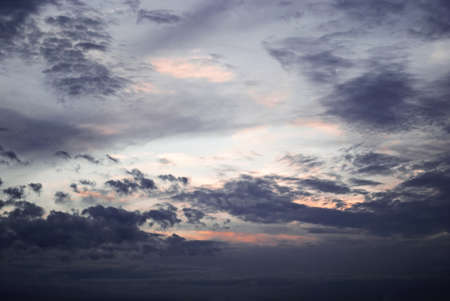 the sun sets in the evening in a cloudの写真素材