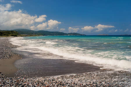 Colorful, beautiful landscape of sea coast with views of the mountains in the distance.の写真素材