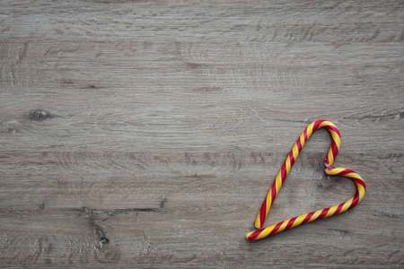 heart made of sugar candies on a wooden backgroundの写真素材
