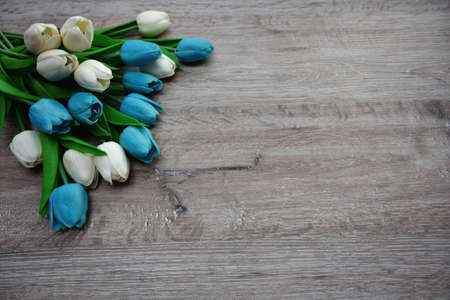 bouquet of multicolored tulips on a wooden background and with an empty place for an inscriptionの写真素材