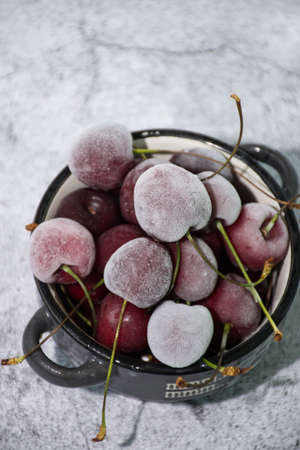 fresh frozen cherry berry on gray backgroundの写真素材