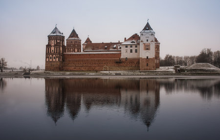 Mir castle in winter on the lake with reflection in the water.のeditorial素材