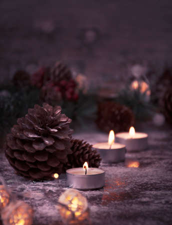 lighted candles, cedar cones and fir branches for Christmas in a homely atmosphere. life styleの写真素材