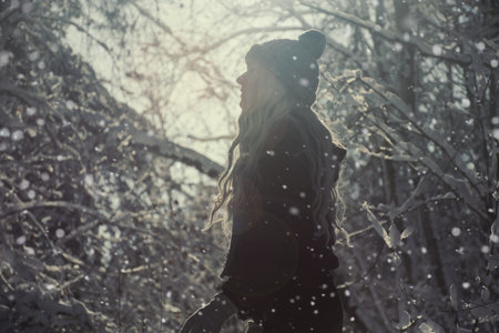 silhouette of a man in the forest in a snowfall illuminated by the sun. soft focus