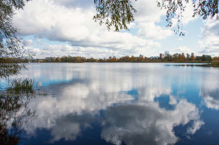 autumn landscape of the river and city houses in the distance
