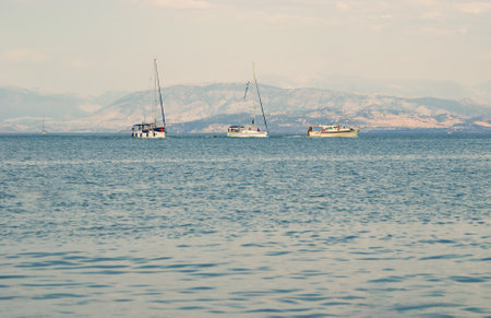 calm seascape with mountain islands and boatsの写真素材