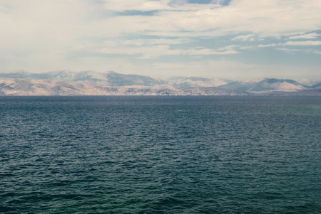 mountain coast on the horizon in the sea, calm landscape of the Greek islandsの写真素材