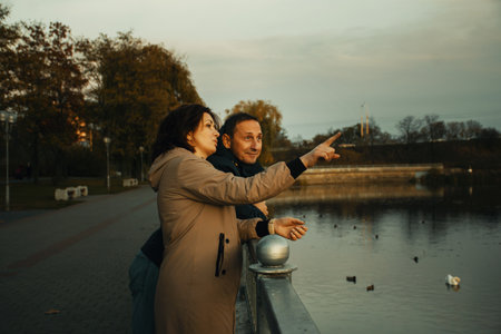 a married couple walks along the embankment, spending time together.の写真素材