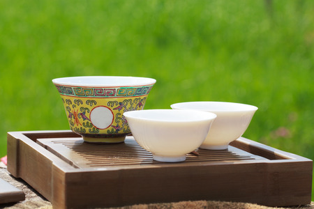 Traditional chinese tea ceremony accessories ( gaiwan and cups) on the tea tableの写真素材