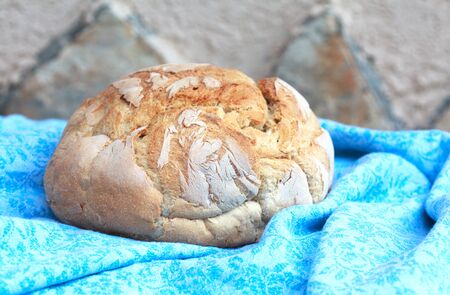 Round Loaf of Home made Bread made from whole wheat flour in rustic style, selective focus