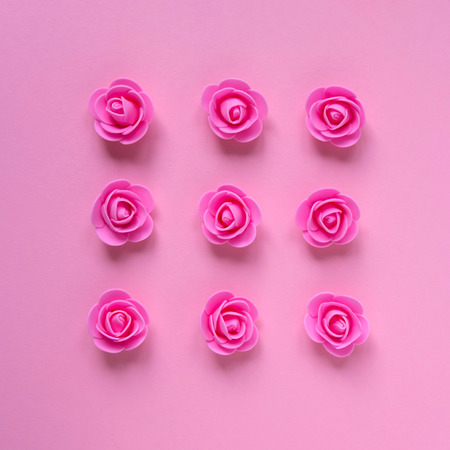 Artificial pink roses on pink background. Flat-lay, overview, holiday, Valentines Day conceptの写真素材