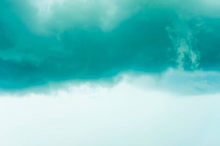 Thunder grey sky with blue clouds. Great backgroundの写真素材