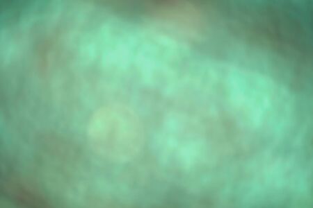 Defocused dynamic abstract green background. Emerald motion effect decorative backdrop. Natural summer blurry light and dark green texture. Fresh no focus plant leaves creative wallpaperの写真素材
