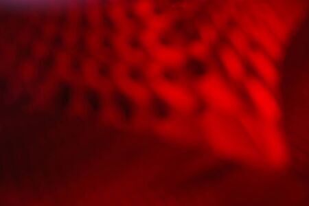 Red abstract relief glamour background. Abstract 3d blurry creative texture. Color distorted surface contemporary backdrop. Rough, uneven burgundy modern horizontal decorative wallpaperの写真素材