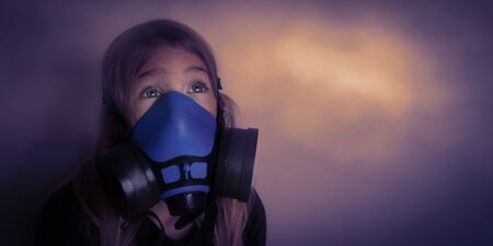 Young girl wearing gasmask, respirator portrait. Effects of worldwide air pollution, industrial influence on environment. Protection from dangerous air particles, gas, smog, transmitted diseasesの写真素材