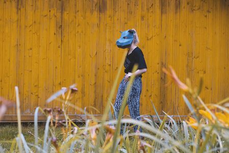 Chekhov, Russia - August 8, 2019: young girl in a rat mask walks down street. Modern woman is in park. New year 2020 conceptのeditorial素材