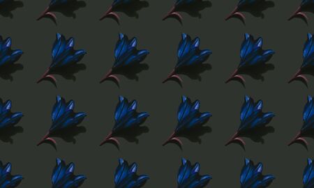 Seamless pattern of blue lilies on dark background trend flat lay concept with fashionable toning. Many flowers patternの写真素材