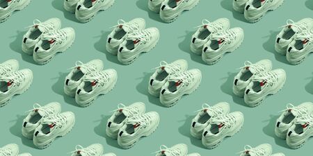 Pair of white sneakers on color background. Sport running concept. Many shoes patternの写真素材