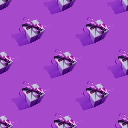 Christmas holiday present composition. Gift, christmas new year and sale concept seamless pattern decoration on lilac backgroundの写真素材