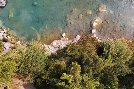 Top view of azure lake with green coast. Beautiful water body captured from drone. Aerial view of picturesque landscape with crystal clear pond. Summer vacation concept. Wild nature paradiseの写真素材