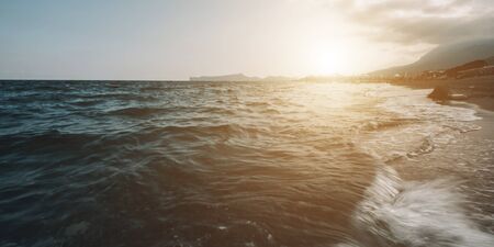 Beautiful ocean sunrise panorama. Scenic seascape. Azure water landscape with blue sky, horizon and white fluffy clouds. Sea turquoise surface. Summer vacation. Wild nature paradise backgroundの写真素材