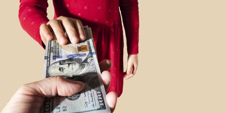Person gives money to child. Kid take dollars from parent. Payment for child labor consept. Children...