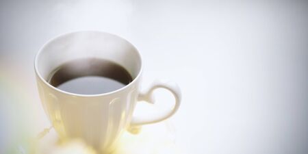 Cup of coffee or tea on table in cafe withwith bokeh lights from the windowの写真素材