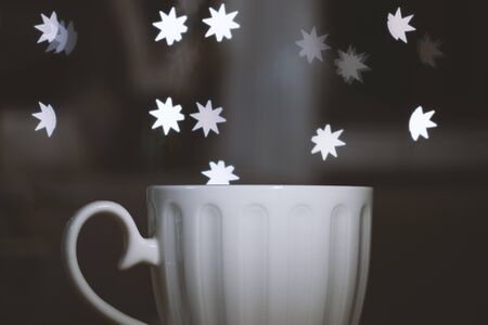 Cup of coffee or tea on table in cafe withwith bokeh lights from the windowの写真素材