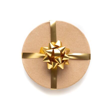 Craft box with golden ribbon isolated on white background. Holiday decoration and gifts. Top view. Valentine present.の写真素材