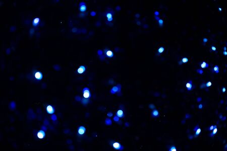 Abstract blur pattern of blue lights on isolated black background. Blue glitter texture christmas abstract backdrop. Christmas light.の写真素材
