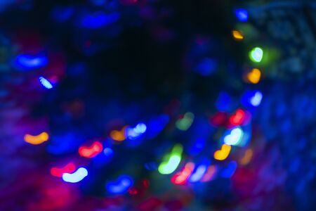 Abstract blur pattern of blue, green, red, yellow lights on isolated black background. Glitter texture christmas abstract backdrop. New Year light.の写真素材