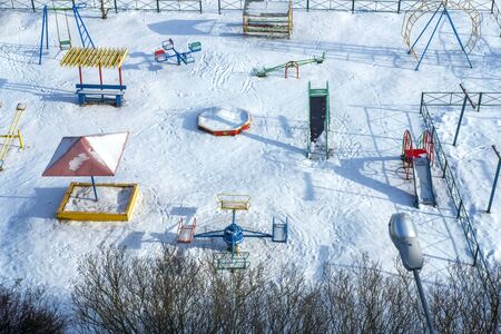 Playground with hard shadows. Sunny day.Bird eye view. Great background for any purposes. Winter and snow landscape. Stock photo.の写真素材