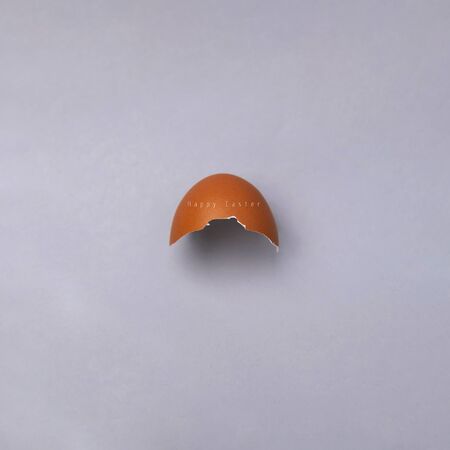 Easter egg, eggshell on gray background with copyspace and text. Banner of macro moody minimalistic...