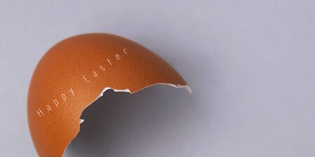 Easter egg, eggshell on gray background with copyspace and text. Banner of macro moody minimalistic...