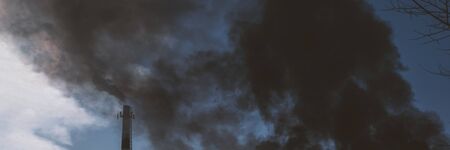 Fire in town. Burning fire with black and white smoke under house. Stok banner photo.の写真素材