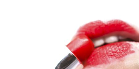 Macro female lips with white teeth and red lipstick on white background with copyspace. Beauty salon, makeup, cosmetics store trendy concept. Stock photo banner.の写真素材