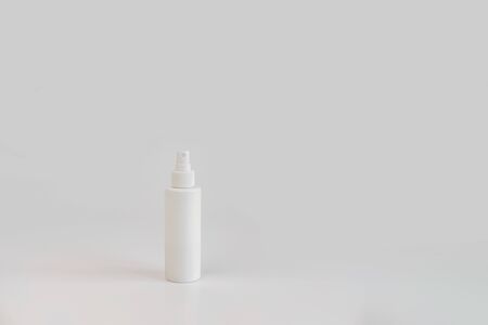 White hand sanitizer cosmetic bottle on gray background with copyspace. New normal concept. Natural, beauty body health cosmetic products.の写真素材