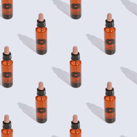 Seamless pattern cosmetic bottle with oil on gray background with hard shadow. New normal concept....