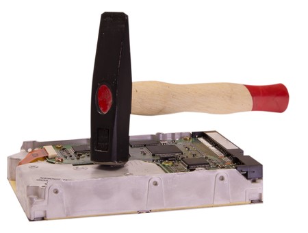 Old hard drive destruction with metalic hammerの写真素材