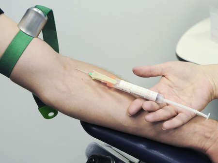 a nurse pricks a patient