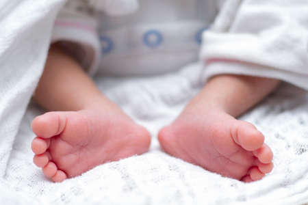 Baby feet with blanket