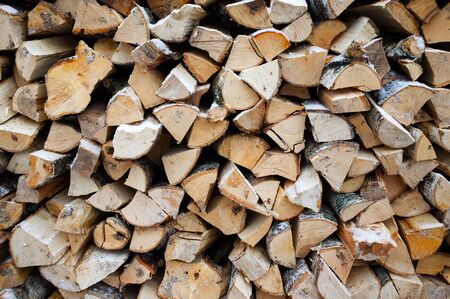 Stack of firewood close-up under the fallen snowの写真素材